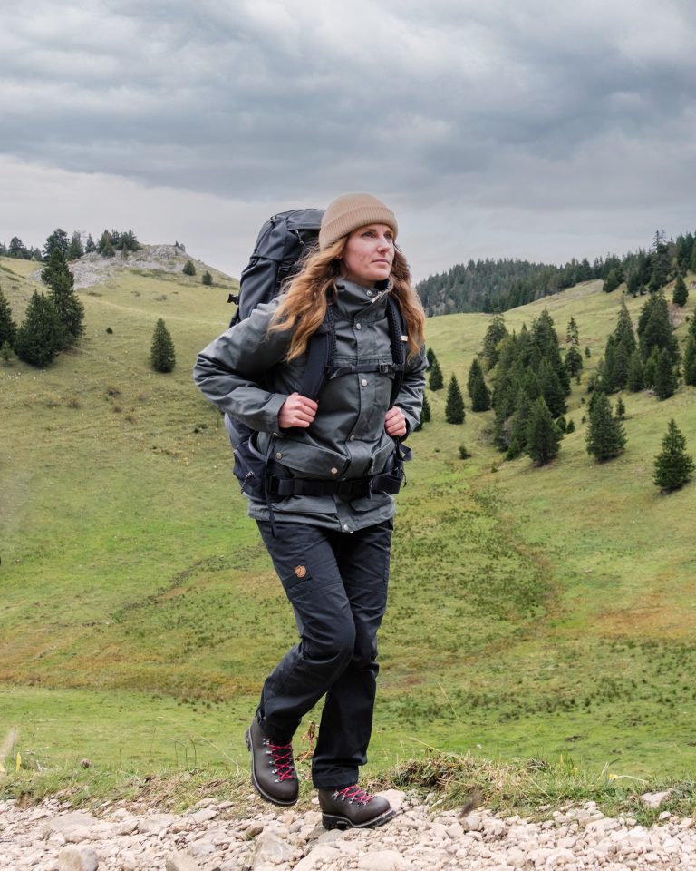 Une randonneuse évolue sur un sentier technique en montagne portant des chaussures Galibier avec semelles Vibram.