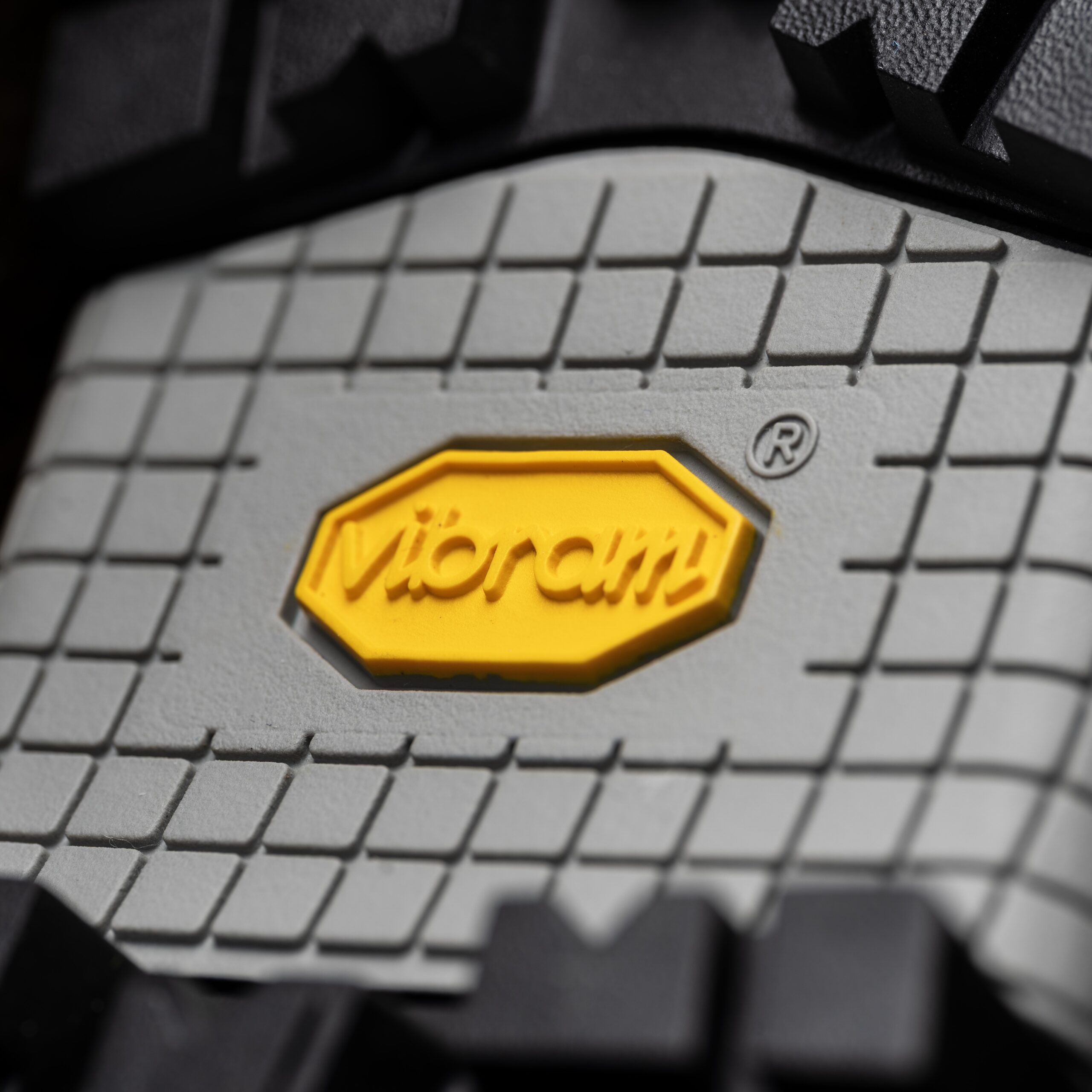 A close-up of a Galibier Super Varappe Low hiking boot made from Perwanger leather, featuring a Sympatex membrane, on a rocky mountain trail.